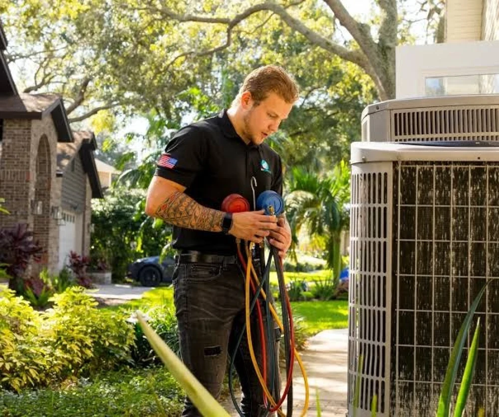 HVAC technician checking AC refrigerant gauges and outdoor condenser pressure in Aviara Carlsbad