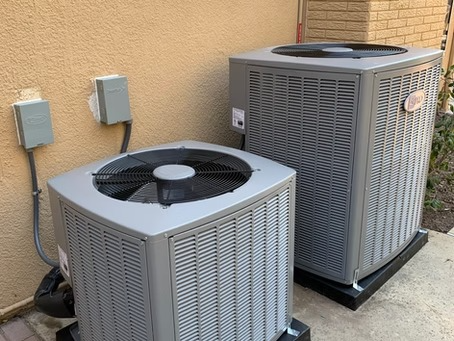 Side by side dual outdoor AC condensers installed in Carlsbad home