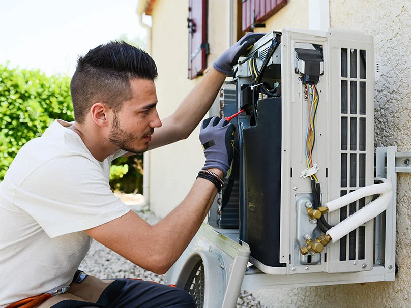 Carlsbad HVAC Pros technician servicing outdoor ductless mini-split electrical components
